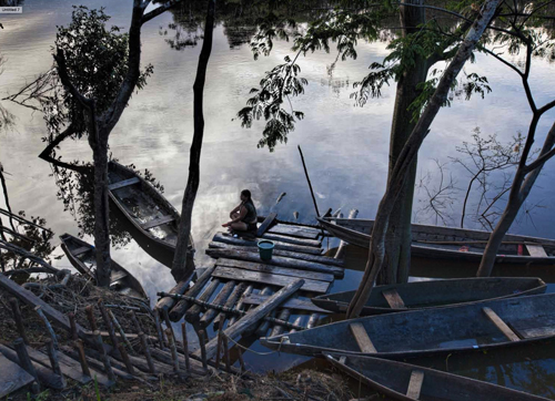 A client waits on one of the docks leading up from the Amazon to the village.
